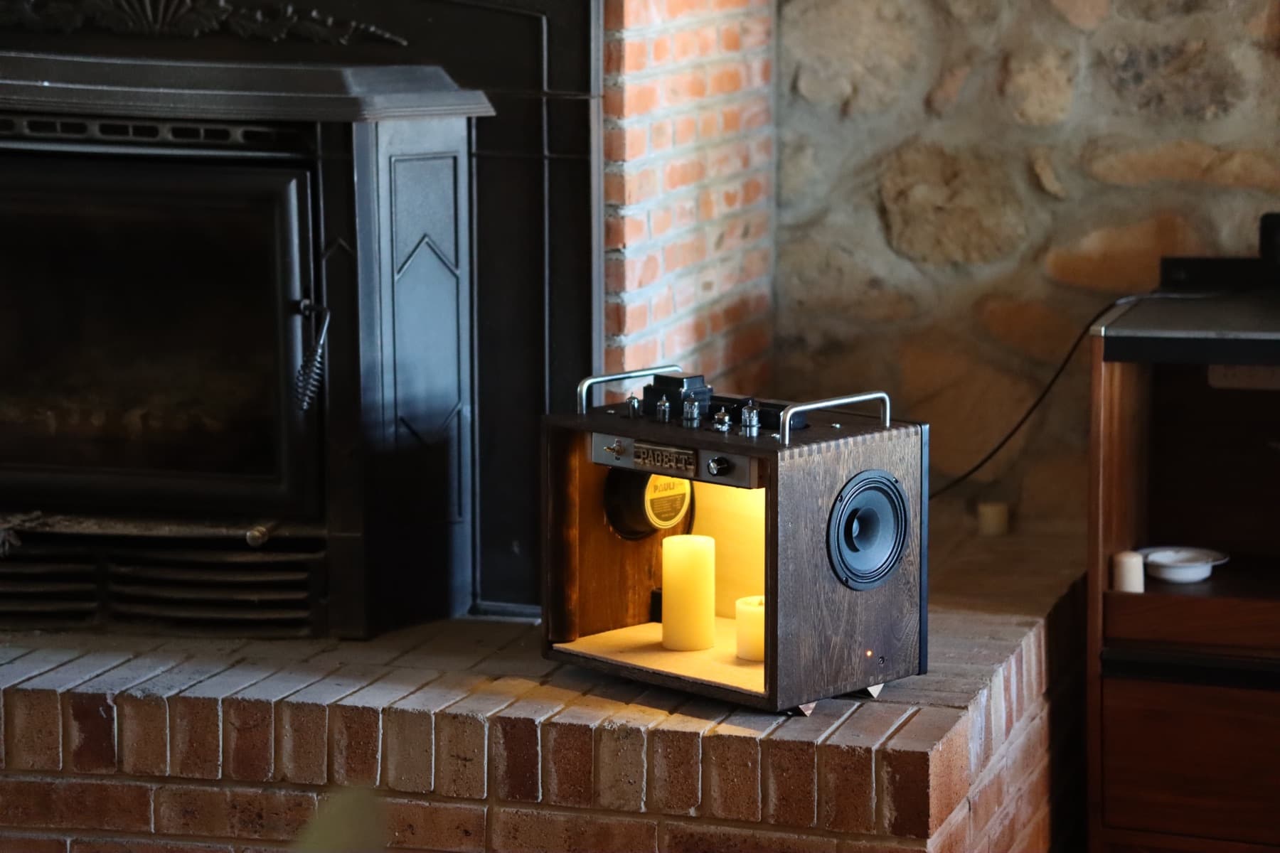 PAGETT VX-1 illuminated beside a fireplace